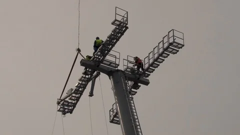 Ka-32 helicopter installs multi-ton structure on support of cable car. Stock Footage 106553162