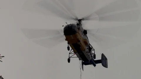Ka-32  helicopter with load in hovering mode next to support. Bottom view Stock Footage 105778189
