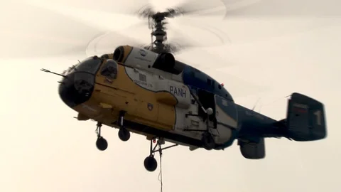 Ka-32 helicopter with a load at  installation of metal structures of cableway. Stock Footage 106771879