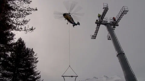 Ka-32 helicopter with multi-ton structure is slowly declining near support. Stock Footage 106491469