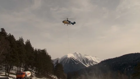 Ka-32 in hovering mode on the background of snow-capped peaks. Stock Footage 106857185