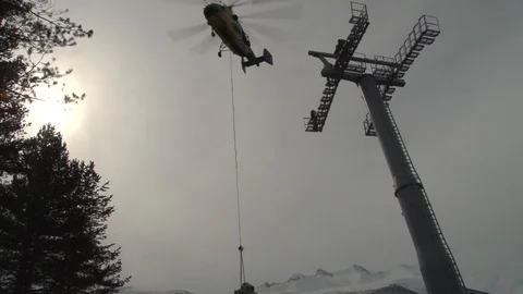 Ka-32 lifts multi-ton metal structure on platform of cable car support. Stock Footage 106799445