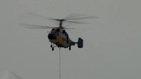Ka-32 with load flies to support on background of snow-capped peaks Stock Footage 106799518