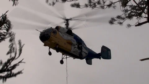 Ka-32 with load rises vertically near support of cable car. Close-up. Stock Footage 106799532