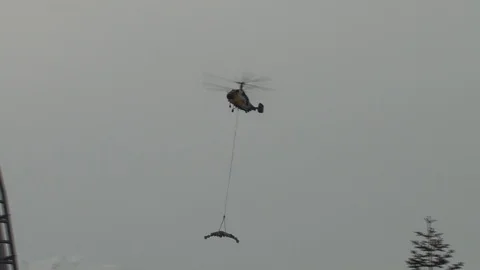 Ka-32 with multi-ton metal structure on  external suspension flies to support Stock Footage 106607455