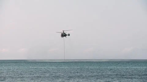 Ka-32A fire and rescue helicopter liquidates  fire in a forest Stock Footage 288604672