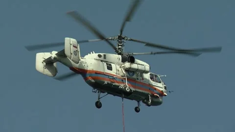 Ka-32A fire and rescue helicopter liquidates  fire in a forest Stock Footage 288606105
