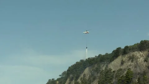Ka-32A fire and rescue helicopter liquidates  fire in a forest Stock Footage 288606249