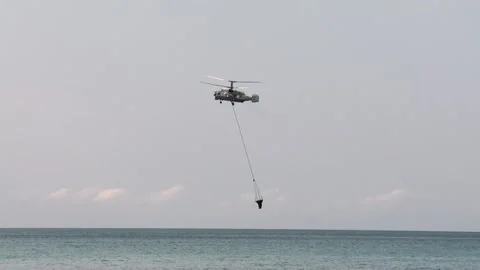 Ka-32A fire and rescue helicopter liquidates  fire in a forest Stock Footage 288606792
