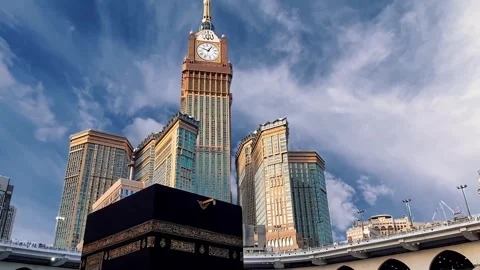 Kaaba and Makkah Royal Clock Tower Under a Blue Sky in Mecca Stock Footage 289462861