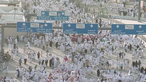 Kaaba Mecca Hajj Muslim people crowd walking toward Muzdalifah Saudi Arabia Stock Footage