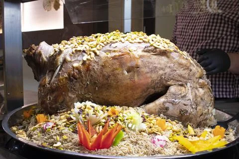 Kabsa, kabsah , mixed rice dish Roasted full lamb on top. Stock Photos