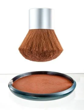 Kabuki brush and compact bronzing powder on a white background Stock Photos