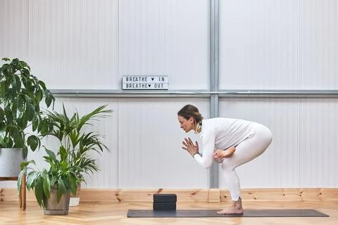 Kakasana postures, meditation while doing yoga of an attractive woman. lifestyle Stock Photos
