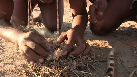 Kalahari Bushmen making a fire Stock Footage 105330573