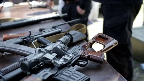 Kalashnikov assault rifles are on the table Stock Footage 113232099