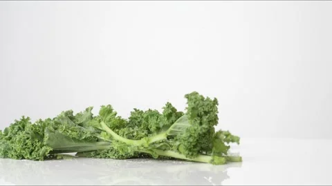 Kale Bouncing Slow Motion White Tabletop Closeup Macro Food Studio Stock Footage 335005100