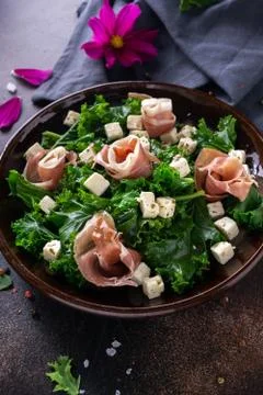 Kale cabbage appetizer with sliced jamon and feta cheese seasoned with olive  Stock Photos