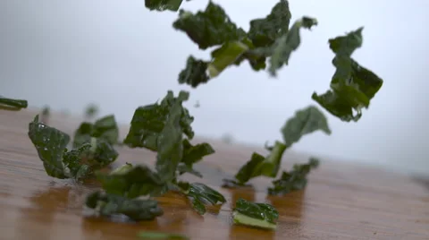 Kale falling in slow motion onto a cutting board - shot on Phantom Flex 4k Stock Footage 64724025