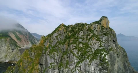 Kamchatka peninsula rocky landscape with cliffs hanging above clean water Stockbeeldmateriaal 291624106