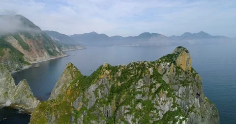 Kamchatka peninsula rocky landscape with cliffs hanging above clean water 動画素材 291624145