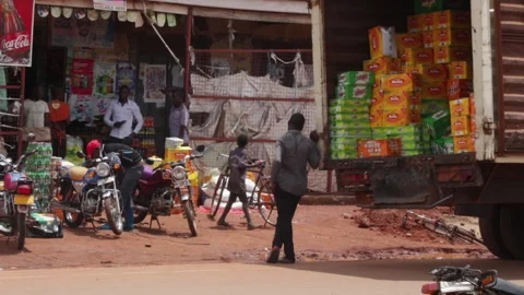 Kampala, Uganda - 10/01/2019: Man unloading crates from a truck in a busy Video stock 278148629