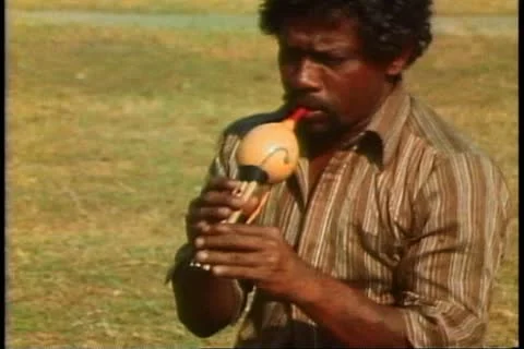 KANDY, SRI LANKA, 1982, A snake charmer in Sri Lanka charms a cobra Stock Footage 10845873