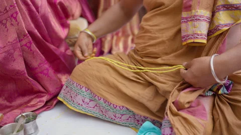 Kannada Wedding Ritual Hands Twisting Yellow Sacred Thread in Bengaluru 動画素材 345942526