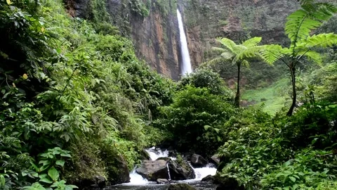 Kapas Biru waterfall seen from a distance Stock Footage 301516645