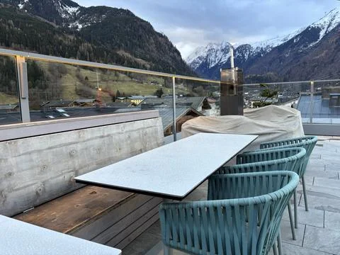 Kaprun, modern rooftop bar without people. snowy mountains background, spri.. Stock Photos