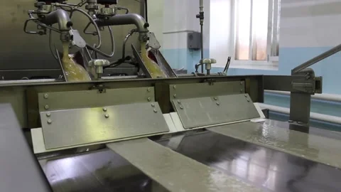 Karamel 012Hot caramel is fed to an automatic conveyor Stock Footage 130395010