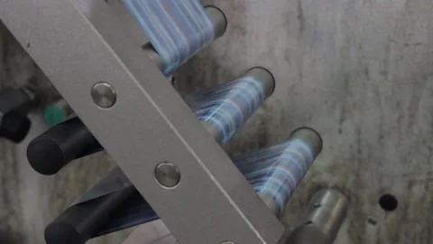 Karamel 047Candy wrappers move on the rollers of the packaging machine. Stock Footage 130395267