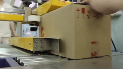 Karamel 072A box of caramel sweets is fed into a packaging machine Stock Footage 130395482