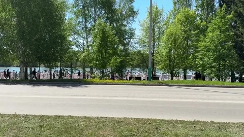 Karate athletes of different ages, mostly children, run along the river Stock Footage 308584397