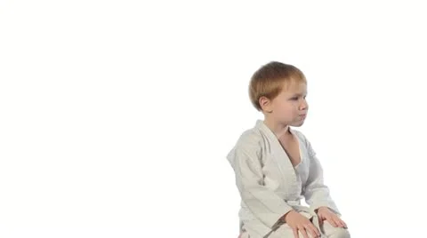 Karate boy exercising isolated against white background Stock Footage 20603033