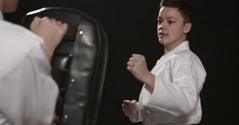 Karate kid punching on bag Stock Footage 50399322