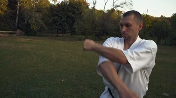 Karate Practitioner A man in White Kimono Makes Gym Qigong Performs Kata In the Stock Footage 85483330