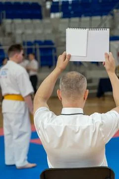 The karate referee shows marks during martial art competition. Stock Photos