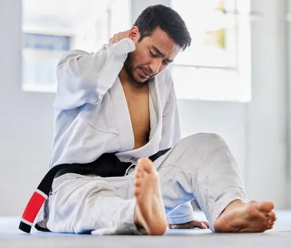 Karate, sports injury and neck pain of man at fitness club for martial arts Stock Photos