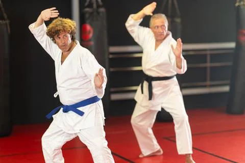 Karate student performing kata with instructor Stock Photos