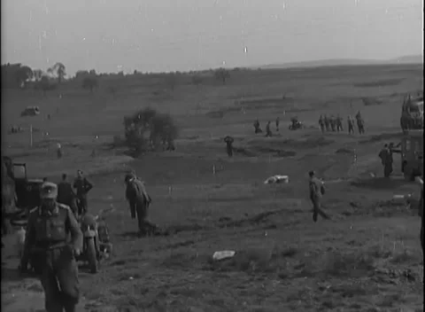 KARLSBAD - 1945: German surrender - Uniformed man crosses a hillside halt Stockbeeldmateriaal 343848507