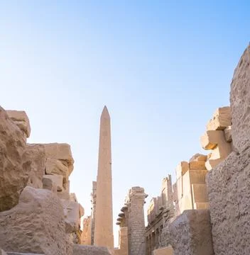 Karnak temple complex in Luxor, Egypt. A majestic obelisk rising among the ru Stock Photos