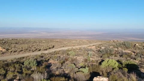 Karoo landscape from mountain looking down on Tankwa Karoo gravel road on le Stock Footage 154600742