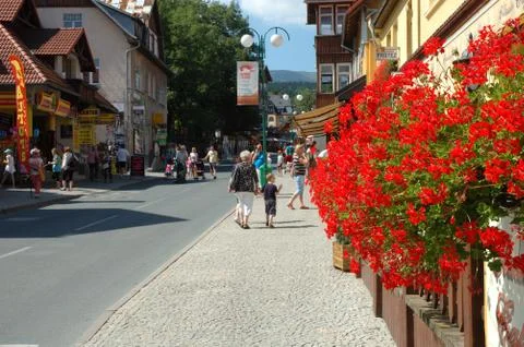 KARPACZ, POLAND - AUGUST 14: Unidentified people and flowers on main street i Stock Photos