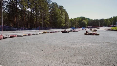 Karting drivers enter the turn behind each other at low speed Stock Footage 111571413