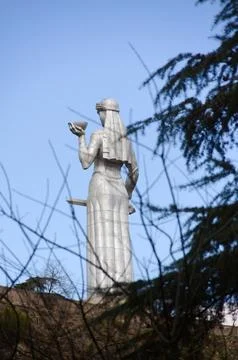 Kartlis Deda Statue Viewed through Pine Branches in Tbilisi, Georgia Fotos de archivo