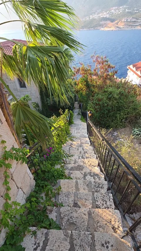 Kas, Turkey - August 22, 2026 Walking down stone stairs with sea view Stock Footage 345145866
