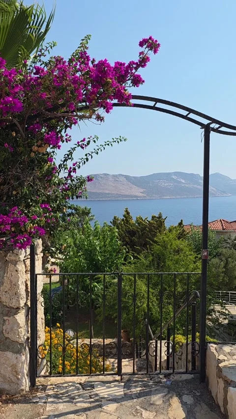 Kas, Turkey - August 23, 2026 Metal arch, bougainvillea and sea view Stock Footage 345145427