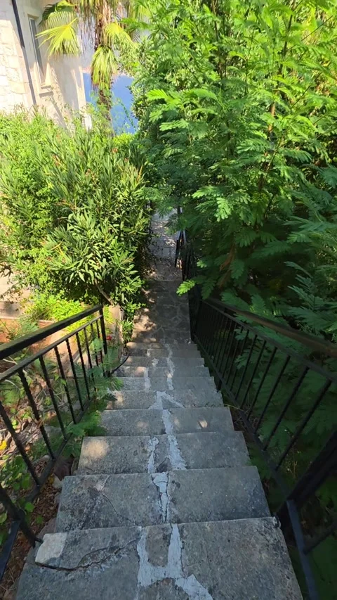 Kas, Turkey - August 23, 2026 Walking down stairs to beach view Stock Footage 345145855