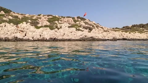 Kas, Turkey - August 25, 2026 Turkish flag on a rocky coast Stock Footage 344642945
